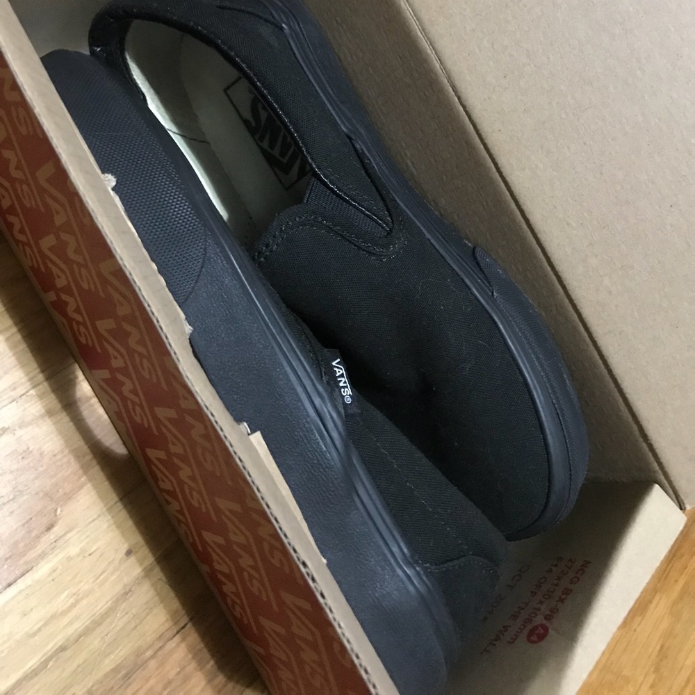 Vans all black slip ons
